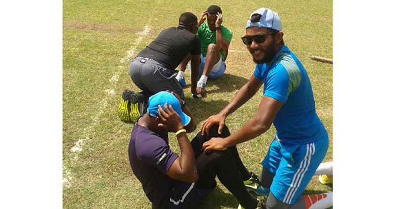 Here we go guys! Four members of the Guyana Jaguars unit, Devendra Bishoo and Veerasammy Permaul (forefront) and Raymon Reifer and skipper Leon Johnson (background), do some abdominal stretches yesterday morning at the Georgetown Cricket Club ground.