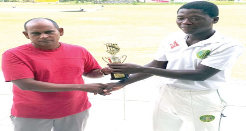 Well done Shurfane! Man- of- the- Match and Demerara’s opening batsman Shurfane ‘Abooboo’ Rutherford smiles as he accepts his spoils from Chairman of the Guyana Cricket Board Junior Selection panel Nazimul Drepaul.