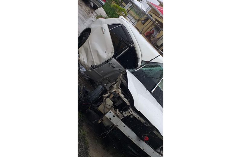 The mangled remains of the motorcar that was being driven by Prakash Salvador, 18, that slammed into the fence of Demerara Distillers Limited (DDL)