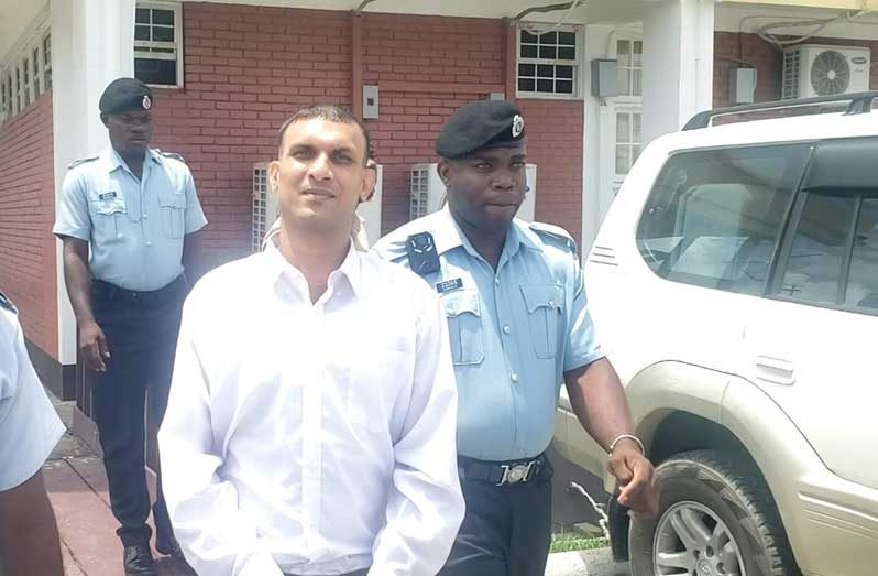 The accused leaving the court as their trial continues in the High Court in Berbice