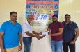 Naven Persaud (second right) of Naven's Construction presents the sponsorship cheque to Secretary of the Demerara Cricket Board Davteerth Anandjit in the presence of members of the organising committee Anil Beharry (right) and Yogeshwar Bishun