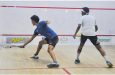 Mikey Alphonso (right) retrieves a drop shot from Mohryan Baksh who lost 3-0 at the GT club on Wednesday night (Sean Devers photos)