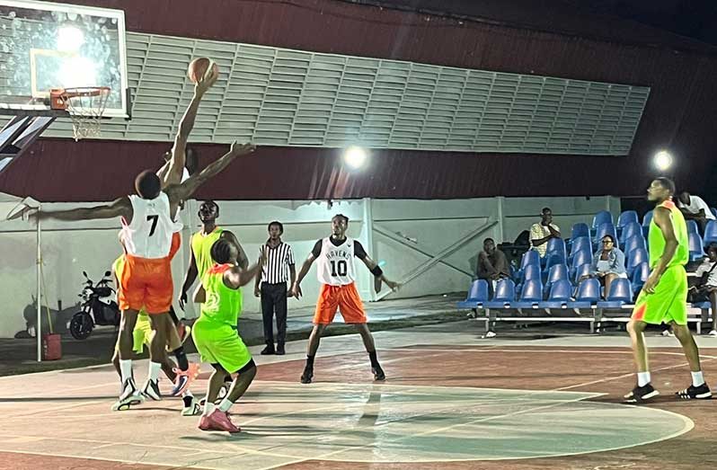 One Guyana basketball Champion North Ruimveldt Ravens (Orange & White) in battle with Pacesetters