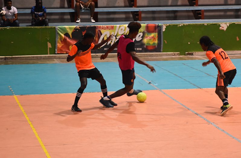 Action from the Sophia and Bent Street clash in the Magnum Tonic Wine Mash Cup Futsal Championship at the National Gymnasium