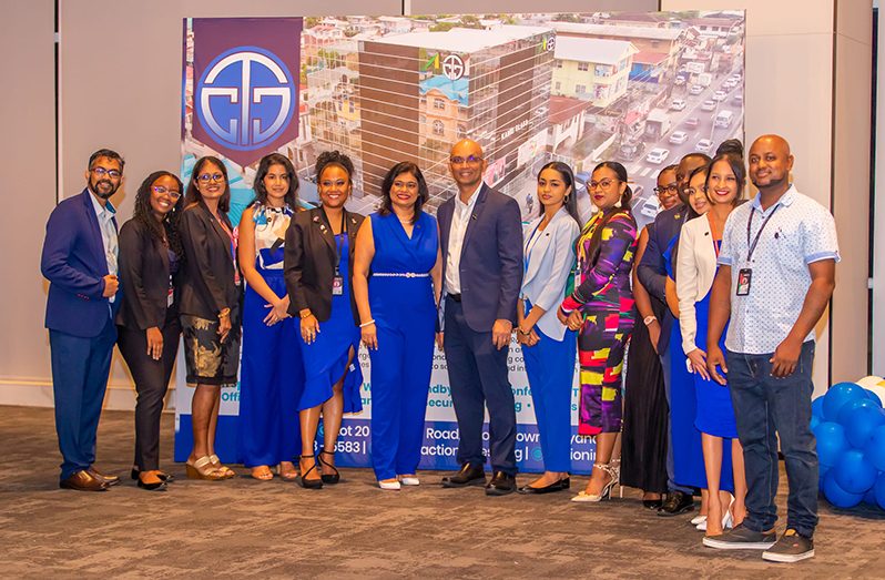 Dr. Vishnu Doerga (centre), Mrs. Davitri Doerga (immediate left), and the team from ActionINVEST Caribbean Inc (ActionINVEST photo)