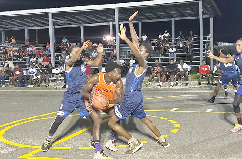 Harold Adams of Royals being sandwiched by two defenders from Amelia’s Ward Jets 