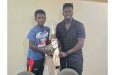 Adrain Emmanuel, left, receives the bat from Kevin Sinclair, right