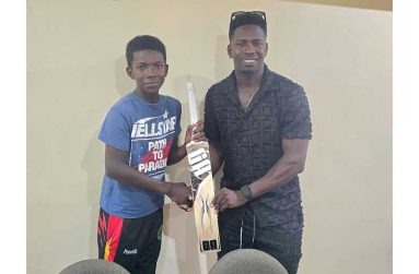 Adrain Emmanuel, left, receives the bat from Kevin Sinclair, right