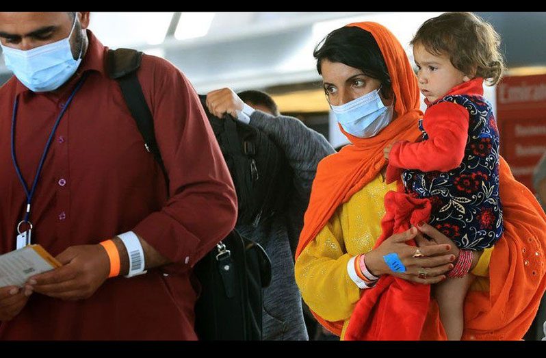 An Afghan woman arrives at Dulles airport after fleeing the Taliban (BBC/GETTY IMAGES)