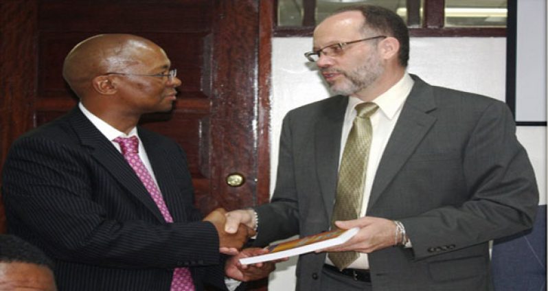 CARICOM Secretary-General, Ambassador Irwin LaRocque (right) presents a copy of the Revised Treaty of Chaguaramas to Ambassador Baso Sanqu (left), Chief Adviser to the Chairperson of the African Union Commission during a courtesy call at the CARICOM Secretariat on Thursday 16 April, 2015.