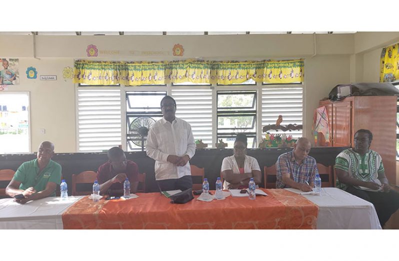 Attorney General, Basil Williams (standing), with CH&PA CEO Lelon Saul (immediate left) and other officials at the head table at Sunday’s meeting