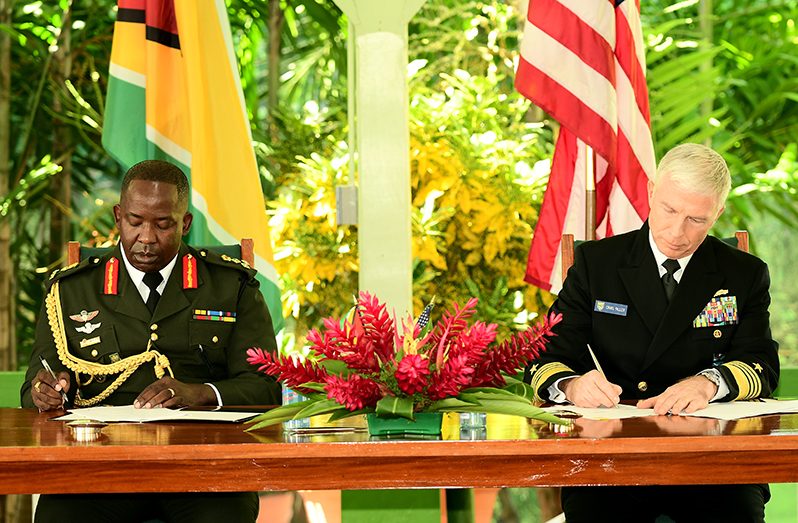 Chief of Staff, Brigadier Godfrey Bess and Commander of the U.S Southern Command, Admiral Craig Faller, sign the Acquisition and Cross-Servicing Agreement that will pave the way for the exchange of goods and services of equal value, to support future Bilateral Defence Cooperation (Adrian Narine photo)