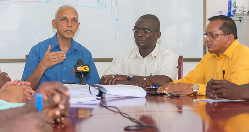 Minister of Communities Ronald Bulkan addressing media operatives in the presence of his Permanent Secretary Emil McGarrell and Managing Director of Puran Brothers Disposal Inc., Lakenauth Puran.