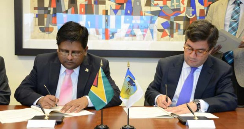 Finance Minister Ashni Singh (left) and President of the IDB, Alberto Luis Alberto Moreno signing the historic agreements