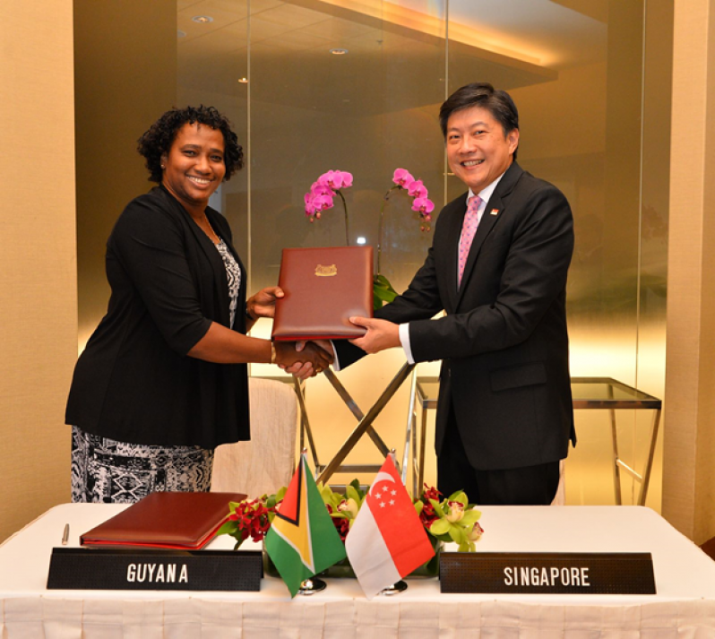 Minister  within the Ministry of Public Infrastructure, Annette Ferguson and Singapore’s Second Minister for Transport, Mr. Ng Chee Meng shortly after signing the agreement. (GCAA photo)