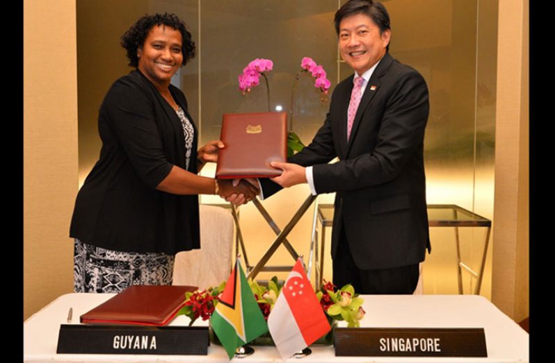 Minister within the Ministry of Public Infrastructure, Annette Ferguson and Singapore’s Second Minister for Transport, Ng Chee Meng shortly after the signing