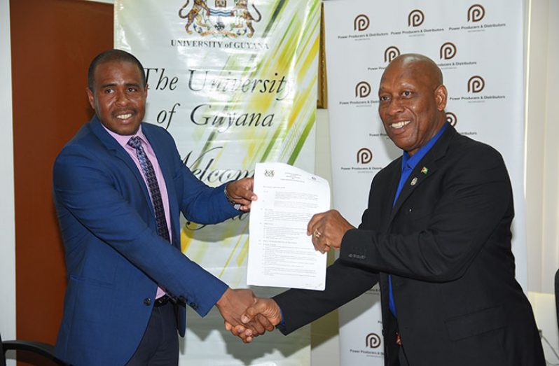 PPDI Chief Executive Officer (CEO), Dr. Arron Fraser and  UG Deputy Vice-Chancellor (Academic Engagement), Professor Michael Scott handing over the agreement