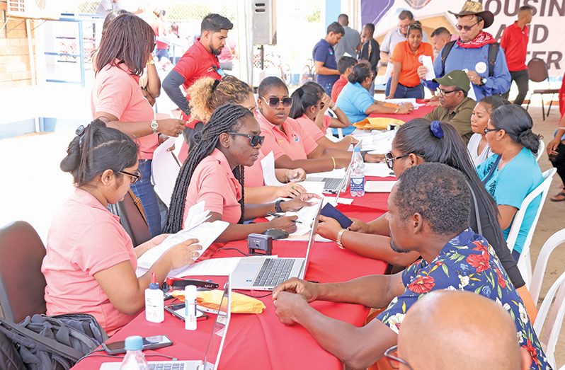 The Ministry of Housing and Water staff processing Agreements of Sale for the initial 150 allottees of the Tract ‘CHPA’ Housing Scheme in Lethem, Region Nine