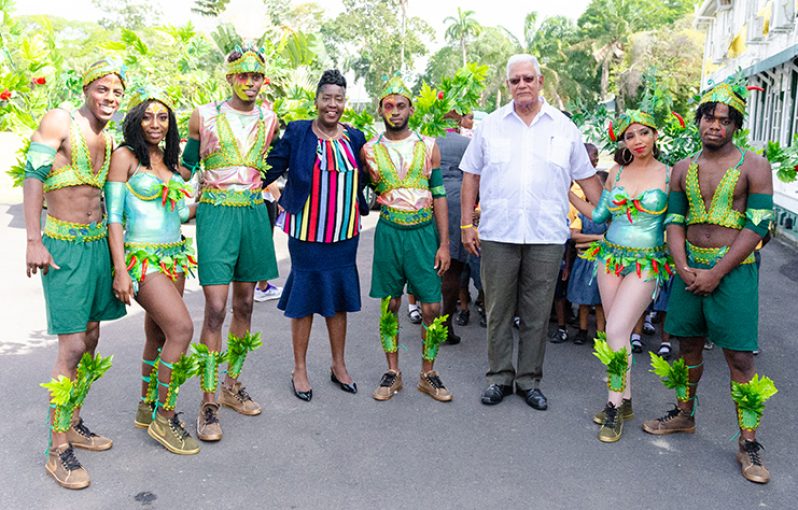 Minister Noel holder and Junior Minister, Valerie Yearwood pose with the revellers displaying the ministry’s costume (DPI photo)