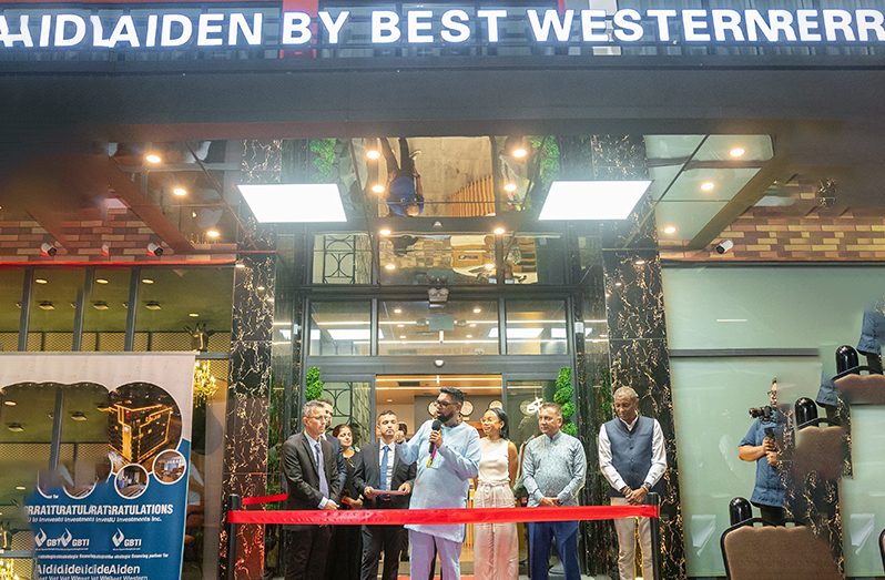 President Dr. Irfaan Ali; Minister of Tourism, Industry and Commerce Oneidge Walrond; CEO of GO-Invest Dr. Peter Ramsaroop; Mayor of Georgetown Alfred Mentore, alongside members of the Alphonso family and hotel executives, cut the ribbon at the grand opening of the Aiden Hotel in Georgetown (Delano Williams photos)