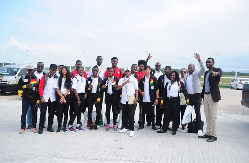 The Guyana team who represented the country  at the South American Youth Games after arriving at the Cheddi Jagan International Airport yesterday. (Delano Williams photo)
