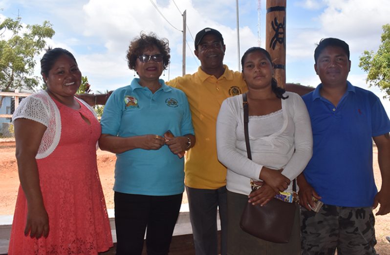 Minister within the Ministry of Indigenous Peoples’ Affairs, Valerie Garrido-Lowe stands alongside villagers who participated in the project