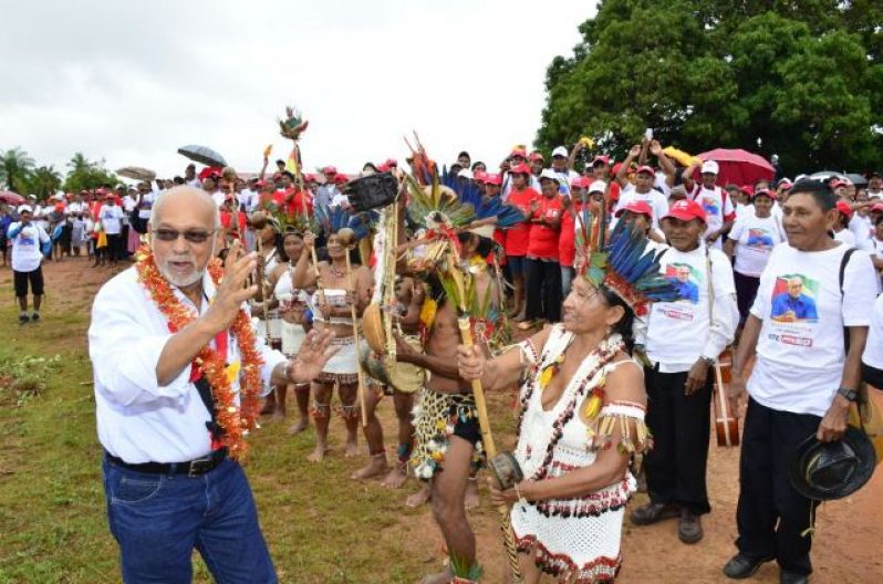 President Donald Ramotar being accorded traditional Amerindian welcome at Aishalton, Region Nine 
