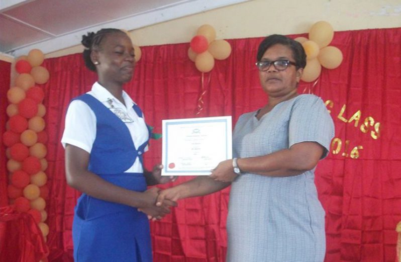 Akila Hopkinson receiving award from Head of Agricultural Science department, Sandra Gibson