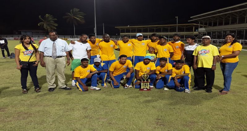The victorious Albion Community Centre Cricket Club pose with their spoils, along with Guyana Beverage Inc. General Manager Robert Selman (with tie) and Marketing Manager Shameiza Yadram (extreme right).
