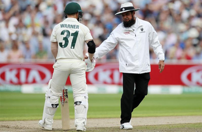 Umpire Aleem Dar talks to Australia's David Warner in the first Ashes Test. (Action Images via Reuters)