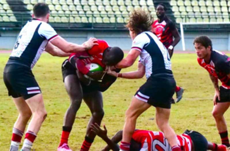 T&T captain Shakeel Dyte attempts to push through Canada’s Alex Russell and Thomas Isherwood during the men’s final in the RAN Sevens tournament.