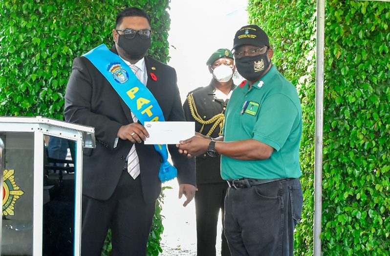 President Irfaan Ali presented a cheque for $1.5M to the Guyana Veterans Legion (GVL) (Office of the President photo)
