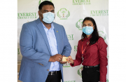 President of Guyana, Dr Irfaan Ali (left) receives his life membership card from Everest Club manager, Krista Norton