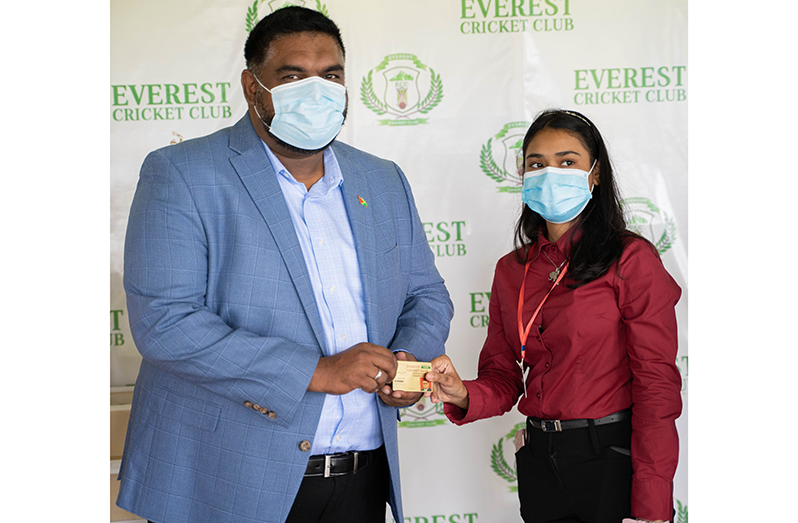 President of Guyana, Dr Irfaan Ali (left) receives his life membership card from Everest Club manager, Krista Norton