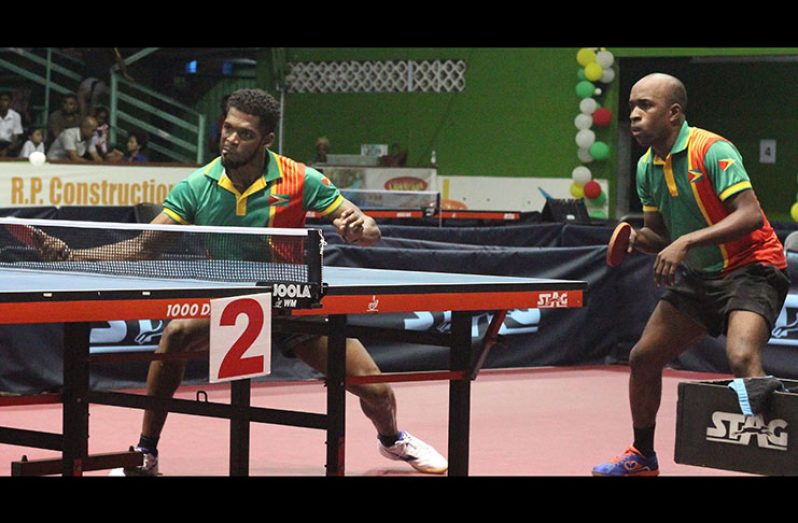 Joel Alleyne (left) spins one back in Guyana’s semi-final clash of the Men’s doubles.