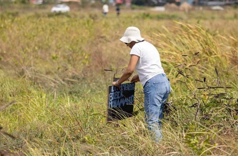 Resident putting down the stake on the newly allotted land
