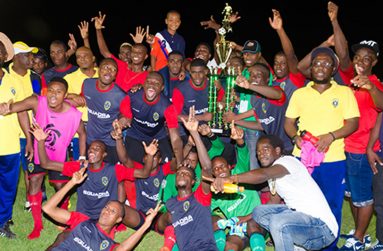 Elite League Champions Alpha United display winning trophy. (Delano Williams photos)