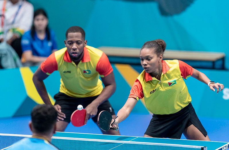 Shemar Britton (left) and Chelsea Edghill battling for Guyana in the Mixed Doubles at the Pan American Games in Chile on Sunday