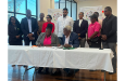 AAG President Amanda Hermonstyne and NACAC Michael Sands signing the MOU in the presence of of other officials