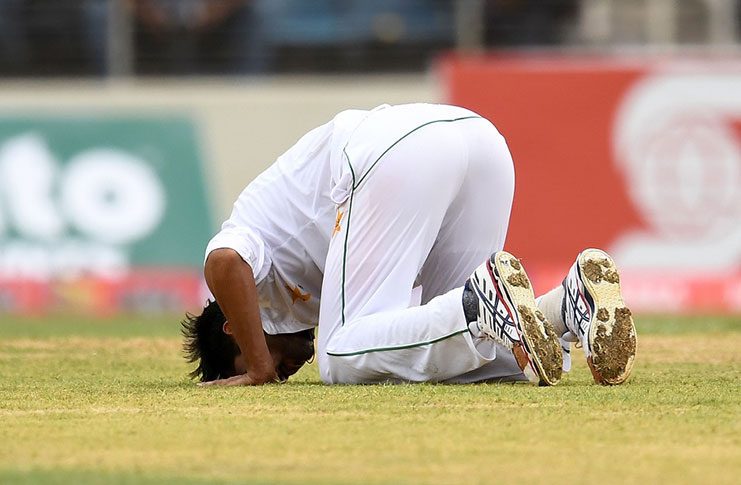 Mohammad Amir performs the sajdah after taking a five-wicket haul on the second day at Sabina Park.