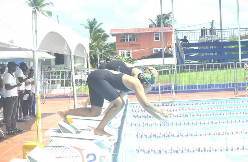 Guyana’s Vieira Andica (front) starts the 200 metres IM, which was won by Suriname (Sean Devers photos)
