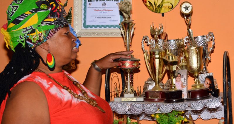 Ann showing off several trophies awarded to the Mocha Dynamic Group  and the Mocha Culture Group (Photos by Samuel Maughn)