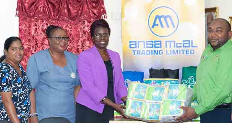 ANSA McAL Representative Joel Lee handing over some of the company’s ABCD diapers to Ministry of Education Permanent Secretary Delma Nedd. Also in photo are SHN HIV/AIDS Representative Janelle Sweatnam (left) and Deputy Chief Education Officer Donna Chapman (second left)