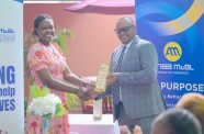ANSA McAL Country Head Troy Cadogan presents Leanna Thompson of Blossom Inc. with the NGO’s Social Investment Award