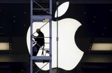 A worker climbs outside an Apple store in Hong Kong, China, in this April 10, 2013 file photo. REUTERS/BOBBY YIP/FILES