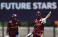 Shamar Apple (right) celebrates his century against Japan, while Tanez Francis (left), who also scored a hundred looks on (Photo by Matthew Lewis-ICC/ICC via Getty Images)