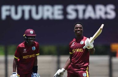 Shamar Apple (right) celebrates his century against Japan, while Tanez Francis (left), who also scored a hundred looks on (Photo by Matthew Lewis-ICC/ICC via Getty Images)