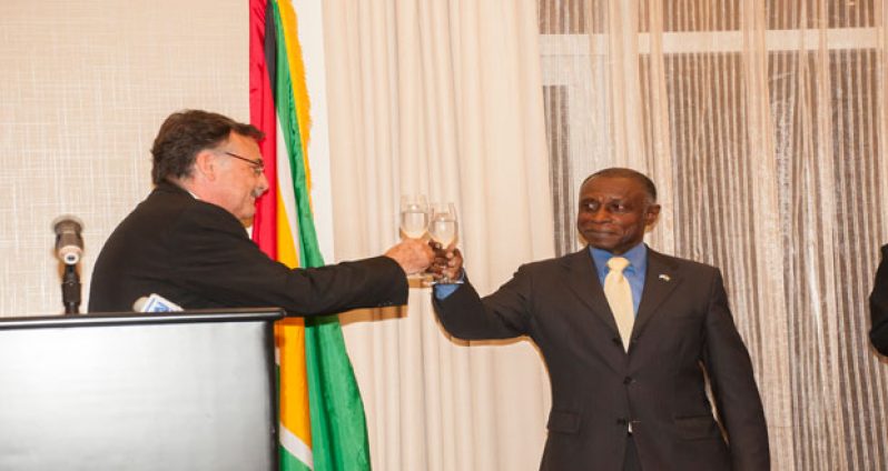 Foreign Minister Carl Greenidge and Ambassador of the Argentine Republic Luis Martino toast to better relations between their two countries
