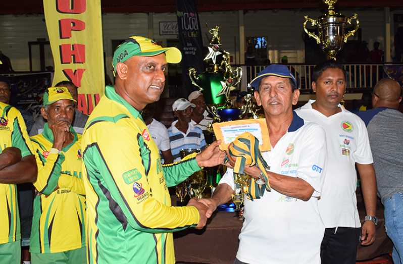 Man-of-the-match Mahendra Arjune collects his award
from GFSCA president, Ramchand Ragbeer.