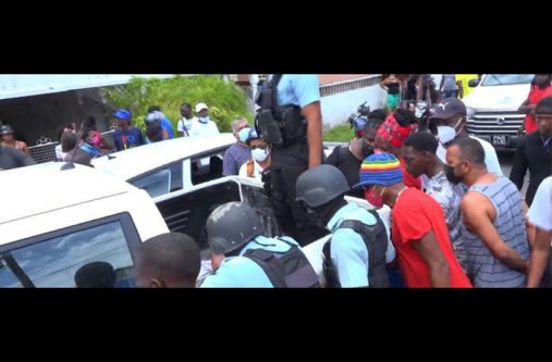 Police ranks arrested the suspects and placed them in the tray of their pick-up as curious onlookers watch